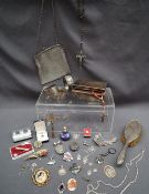 A silver backed mirror, together with a silver cigarette box, silver bangles, silver medallions,