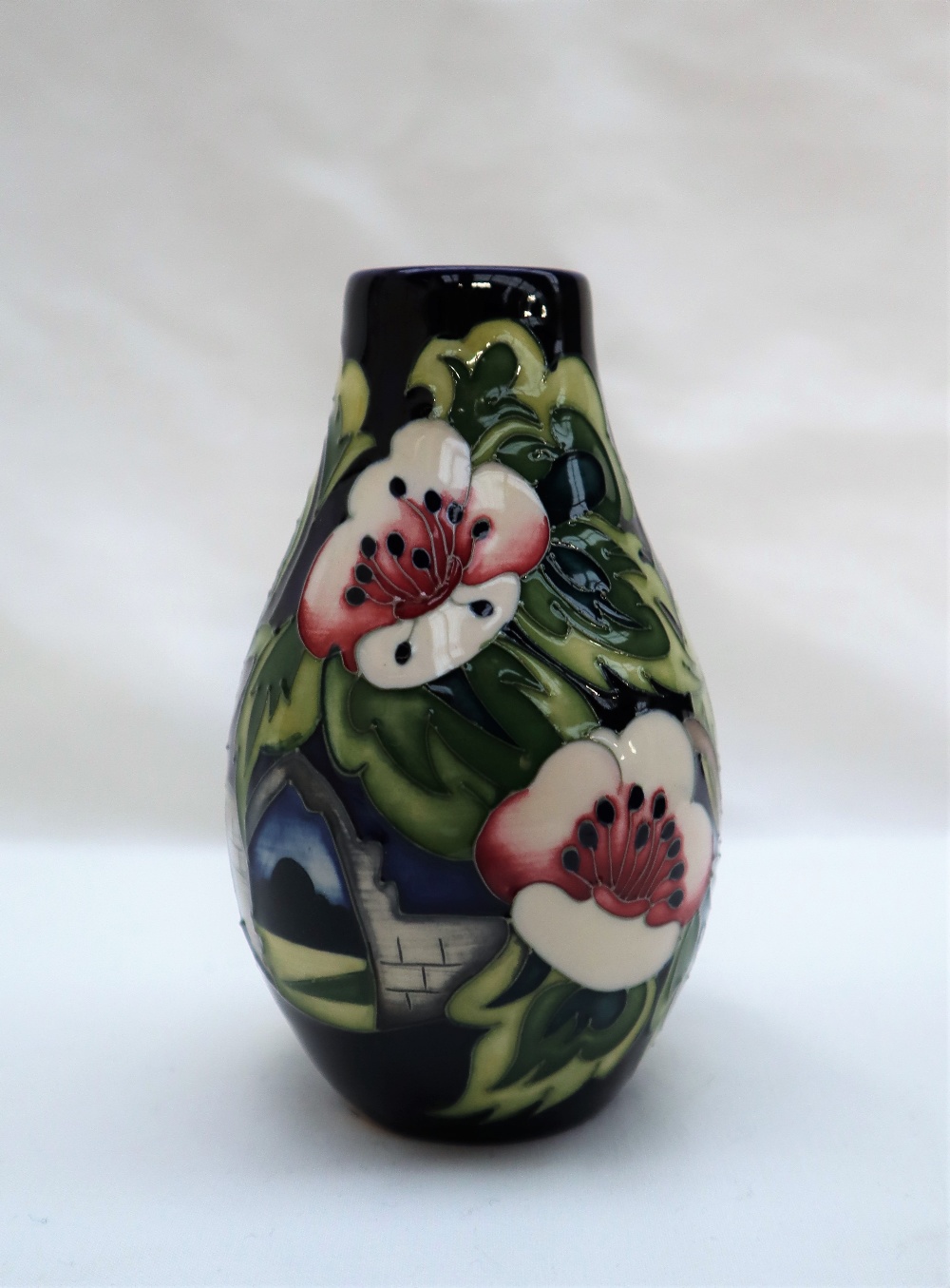 A limited edition Moorcroft pottery vase decorated with pears and flowers, dated 2010,