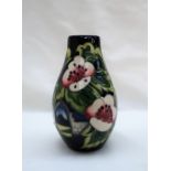 A limited edition Moorcroft pottery vase decorated with pears and flowers, dated 2010,