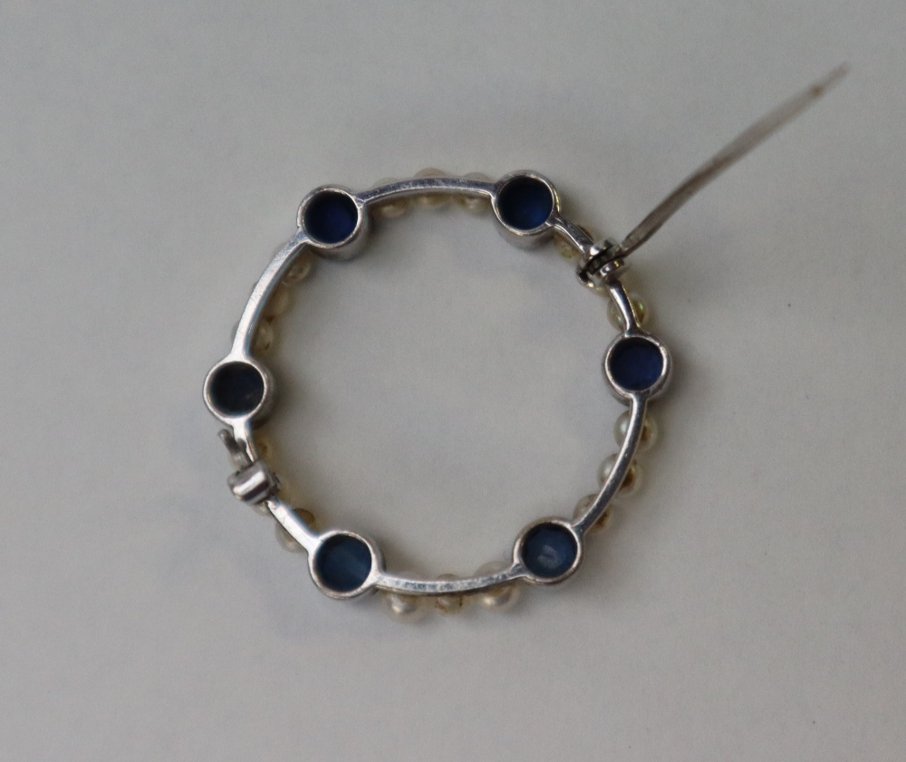 A sapphire and pearl brooch, of circular form set in white metal marked 9ct, approximately 3. - Image 5 of 6