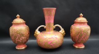 A trio of Derby porcelain vases with a pale pink ground and gilt highlights depicting flowers and