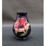 A Moorcroft anemone pattern vase, with a royal blue ground, silver line second quality, 9.