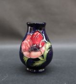 A Moorcroft anemone pattern vase, with a royal blue ground, silver line second quality, 9.