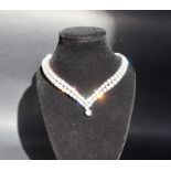 A diamond necklace set with round brilliant cut diamonds, graduating from 0.25ct to 0.