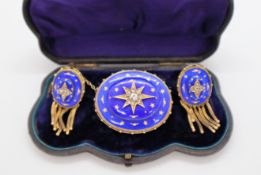 A Victorian yellow metal, diamond, and blue enamel brooch of oval form,