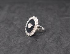 A diamond and onyx dress ring,