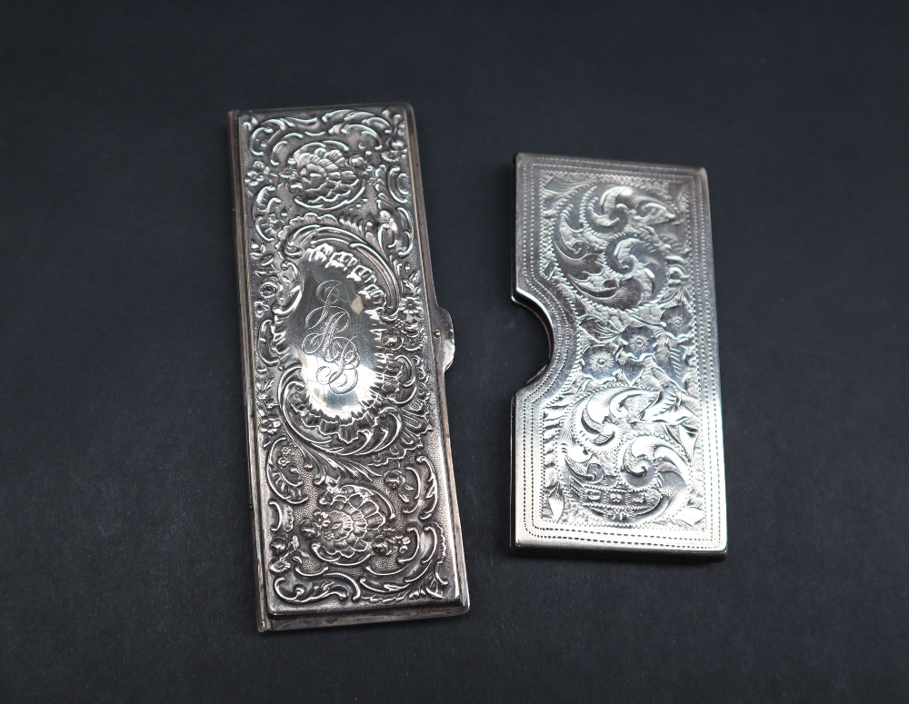 A late Victorian silver card case of rectangular form, decorated with flowerheads and leaves,