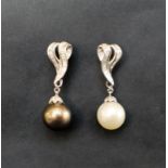 A pair of pearl and diamond drop earrings, one with a black pearl,