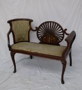 An Edwardian mahogany two seater settee, the central oval pierced panel with marquetry decoration,