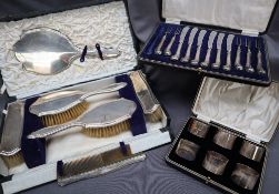 A George V silver dressing table set, comprising a hand mirror, two hair brushes,