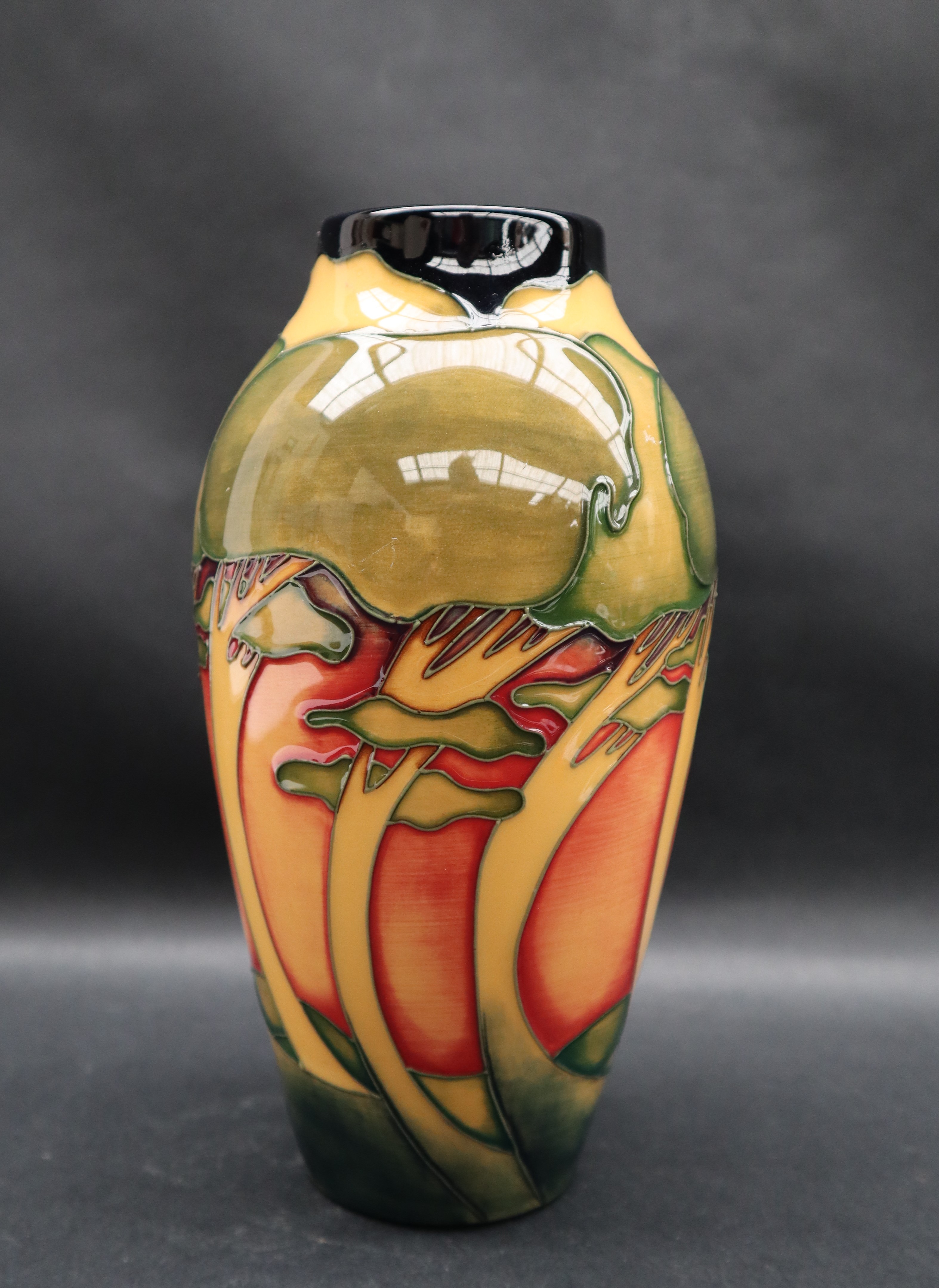 A Moorcroft pottery vase decorated with swaying trees to an orange ground, - Image 2 of 6