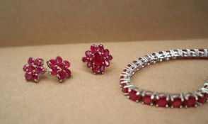 Gemporia - A ruby tennis bracelet to a silver setting together with a silver ruby set ring and