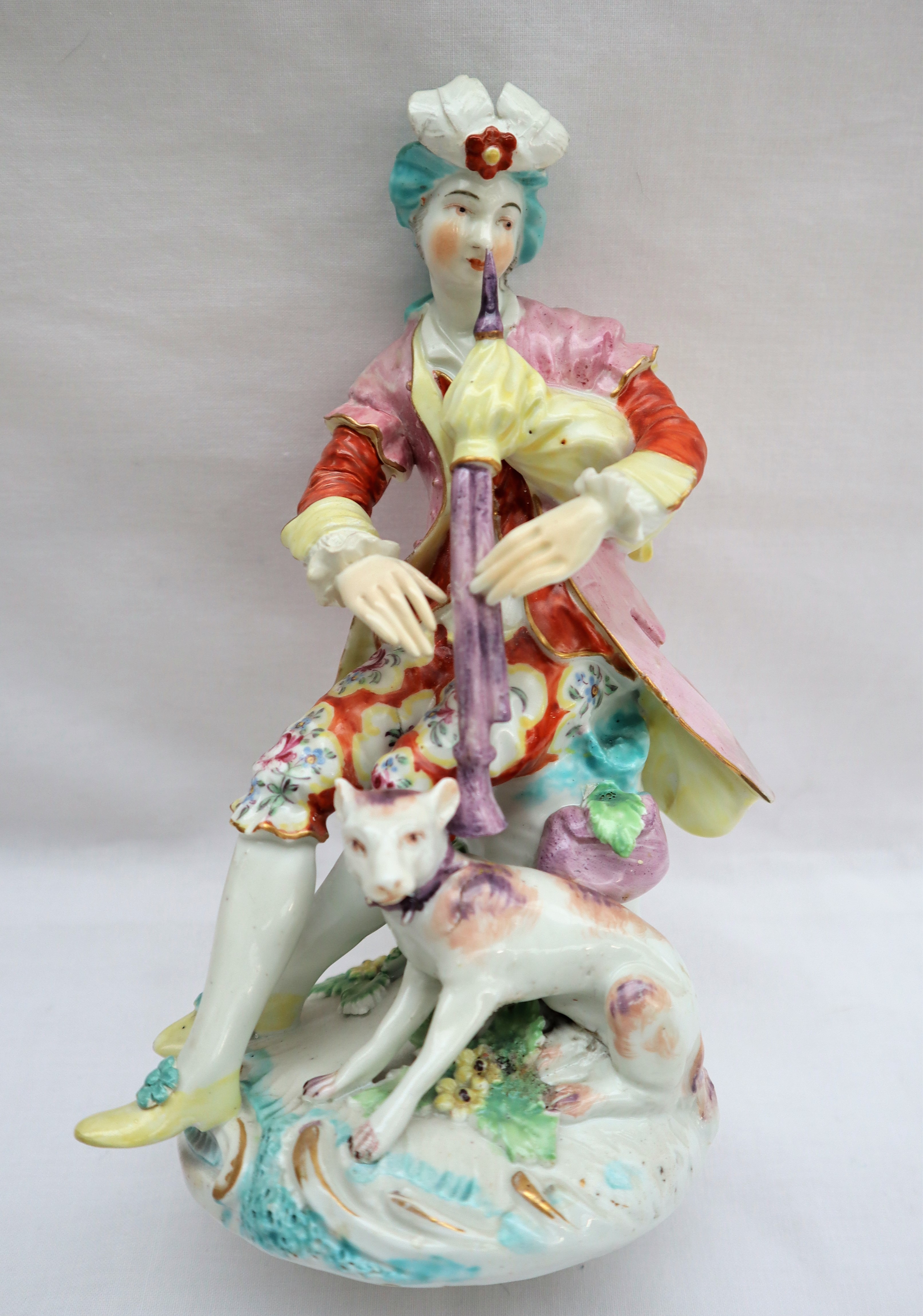 A Derby porcelain figure seated playing bagpipes with a dog at his feet on a circular base, 19. - Image 2 of 8