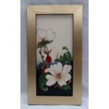 A Moorcroft pottery plaque, decorated with flowers and buds to a cream ground,
