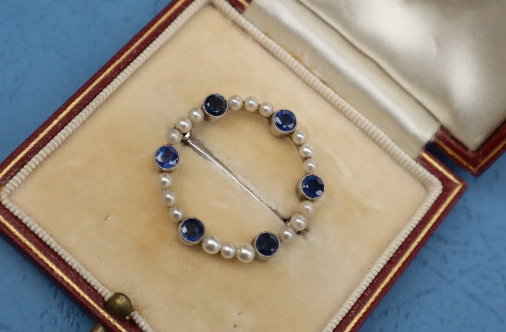 A sapphire and pearl brooch, of circular form set in white metal marked 9ct, approximately 3. - Image 2 of 6