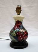 A Moorcroft pottery table lamp decorated with lilies and leaves, 39.