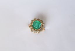 An emerald and diamond dress ring, set with an emerald cut emerald approximately 9mm x 8mm,