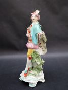 A Derby porcelain figure in a tricorn hat and turquoise cape holding a spray of garden flowers