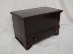 An 18th century oak coffer bach, the rectangular hinged top above a base drawer on bracket feet,