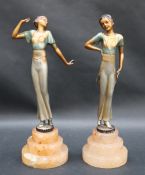 A pair of Art Deco style figures of young ladies in tradition dress on stepped bases, 24.