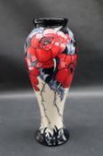 A Moorcroft pottery a More sacred place vase decorated with poppies, impressed mark,