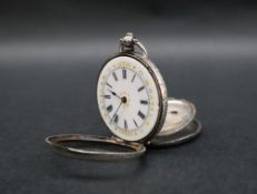 A continental white metal fob watch, with an enamel dial and Roman numerals,