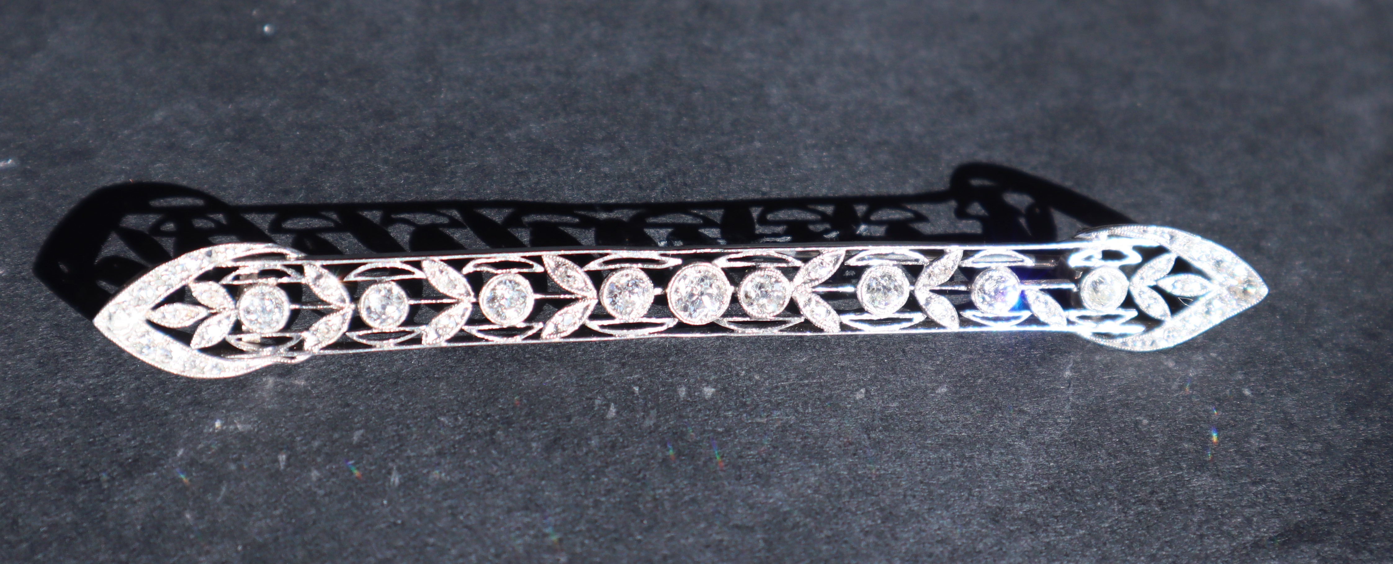 A Victorian diamond bar brooch, set with round old cut diamonds to a white metal wirework setting, - Image 4 of 6