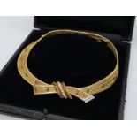 An 18ct yellow gold Kutchinsky necklace set with diamonds, rubies, emeralds,