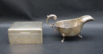 A George V silver sauce boat, with a leaf capped scrolling handle, Birmingham, 1940,