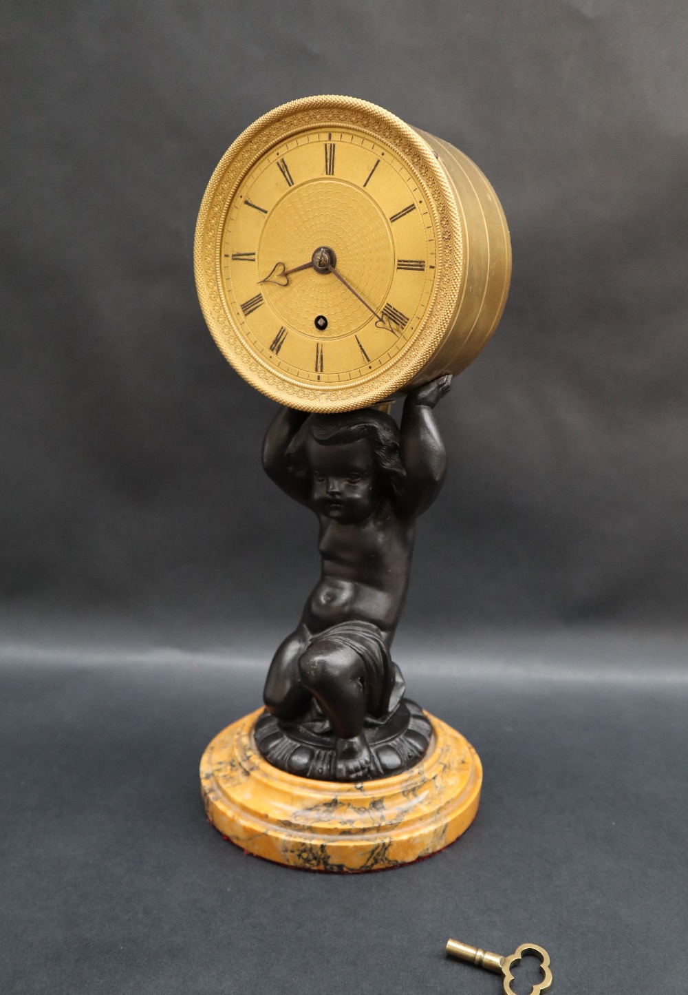 An early 19th century English gilt drum clock,