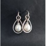 A pair of pearl and diamond earrings, of hoop shape with a suspended pear shaped pearl ,