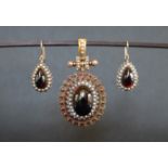 A Victorian yellow metal and seed pearl and paste set pendant with matching earrings,
