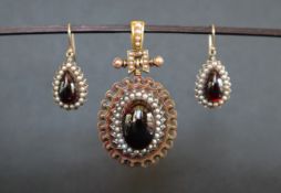 A Victorian yellow metal and seed pearl and paste set pendant with matching earrings,
