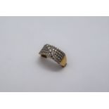 An 18ct gold ring set with five lines of round brilliant cut diamonds with a band of five round