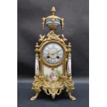 A 19th century French ormolu clock with a porcelain urn surmount,