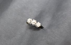 A three stone diamond ring, set with cushion cut diamonds,