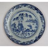 A Chinese blue and white porcelain charger, painted to the centre with figures by a tree,