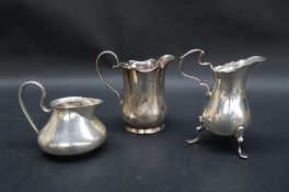 An Edward VII silver cream jug of baluster form on three legs, Chester,