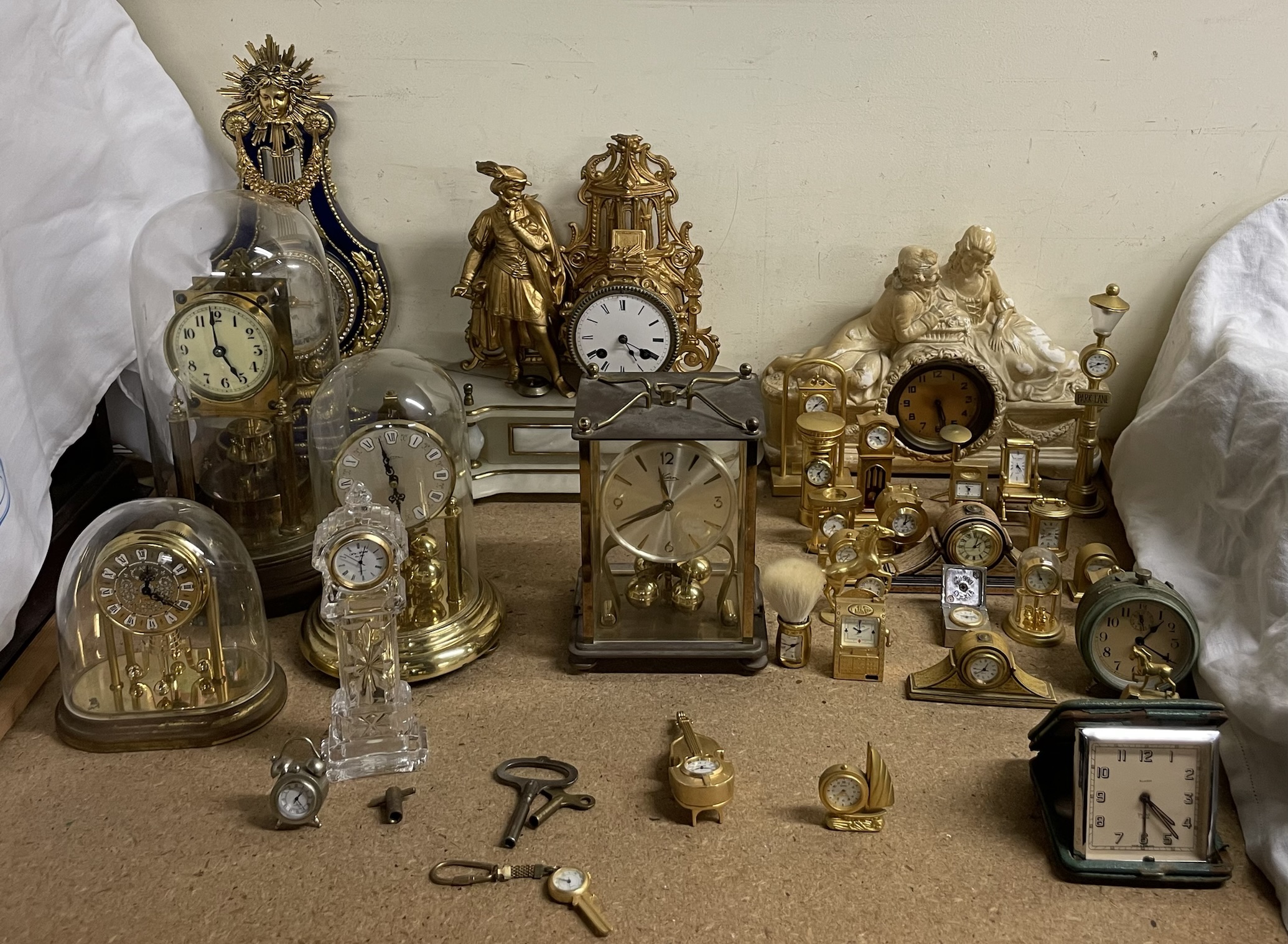 A gilt metal and alabaster mantle clock, together with anniversary clocks, plaster clock,