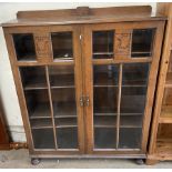 A 20th century oak display cabinet,