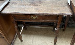 A 20th century oak side table with a rectangular planked top above a frieze drawer on turned legs