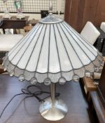 A Tiffany style table lamp with opaque glass tapering panels on a tapering chrome base