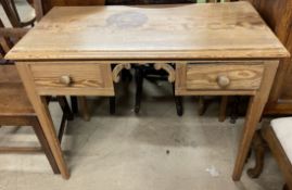 A pine side table with a rectangular top above two drawers on square legs