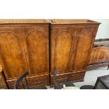 A pair of reproduction yew wood wardrobes, with a moulded cornice and drawers to the base,