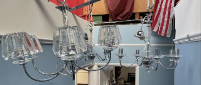 A pair of chrome and glass five branch chandeliers together with another chandelier
