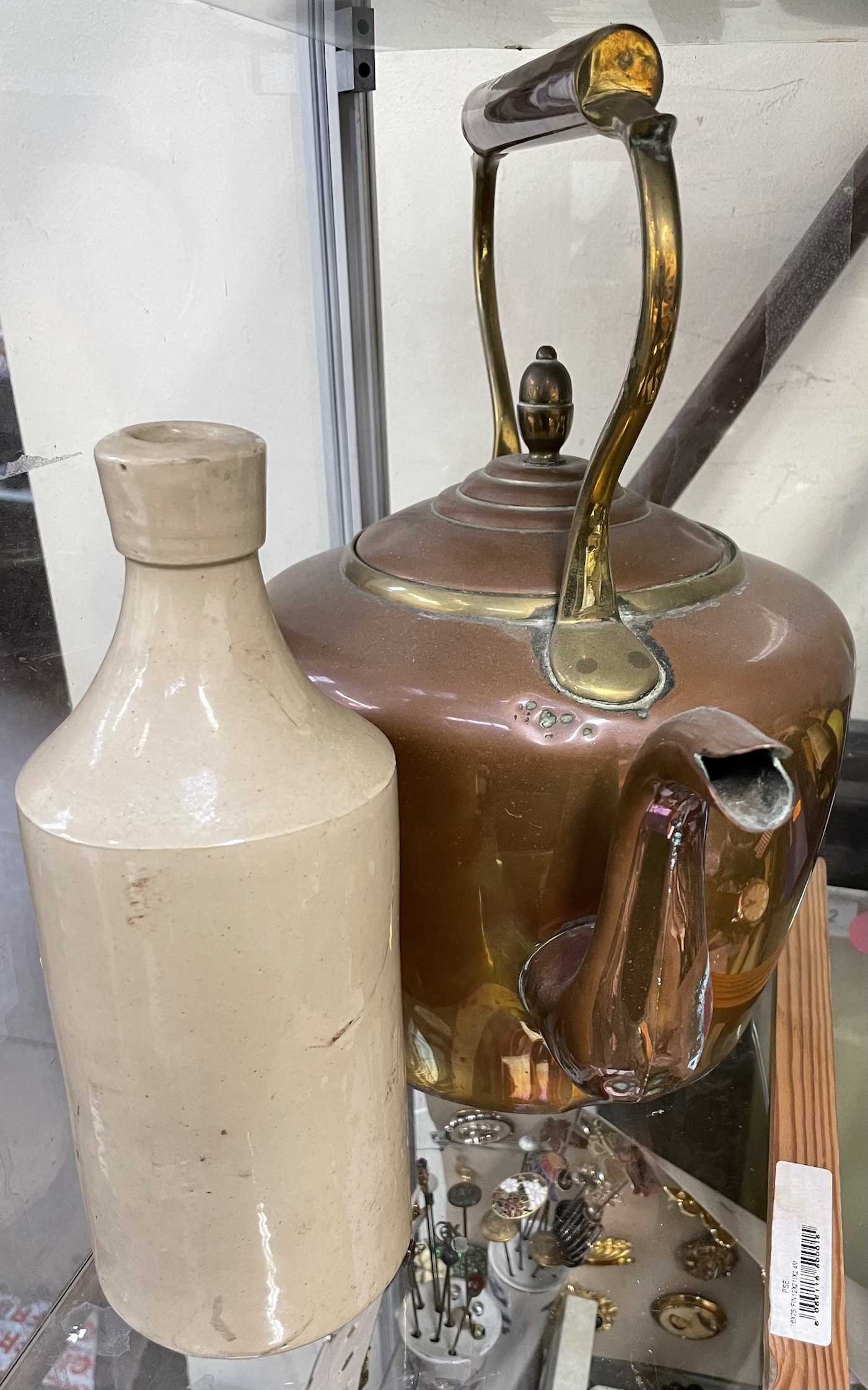 A copper kettle together with a stoneware bottle