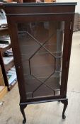 A reproduction mahogany display cabinet with a rectangular top and an astragal glazed door on