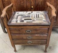 A piano stool with three drawers on square legs