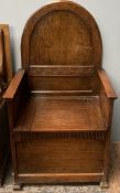 A 20th century oak box chair with an arched back and box seat on square legs