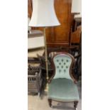 An Edwardian mahogany framed nursing chair together with a brass standard lamp